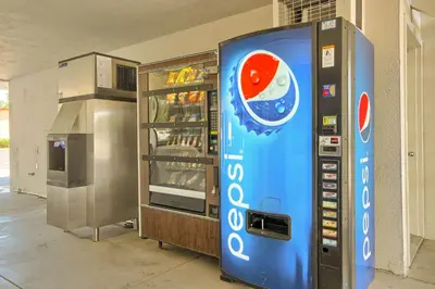 a drink vending machine next to a drink cooler at Motel 6-Fresno, CA - Blackstone North in Fresno