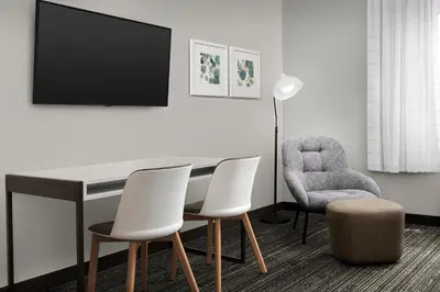 a room with a table and two chairs and a tv at TownePlace Suites Sacramento Cal Expo in Sacramento