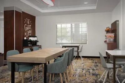 a dining room with a wooden table and chairs at TownePlace Suites Sacramento Cal Expo in Sacramento