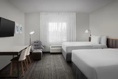 a hotel room with two beds and a desk at TownePlace Suites Sacramento Cal Expo in Sacramento