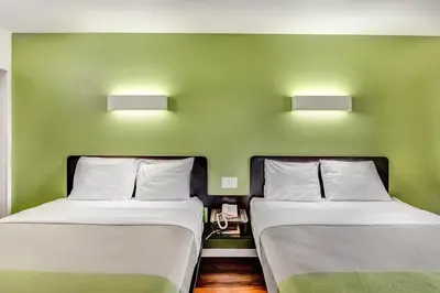 two beds in a room with green walls at Motel 6-Visalia, CA in Visalia