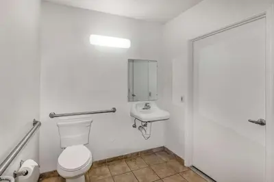 a bathroom with a toilet and a sink at Motel 6-Visalia, CA in Visalia