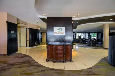 a lobby of a hotel with a sign on a column at Courtyard by Marriott Merced in Merced