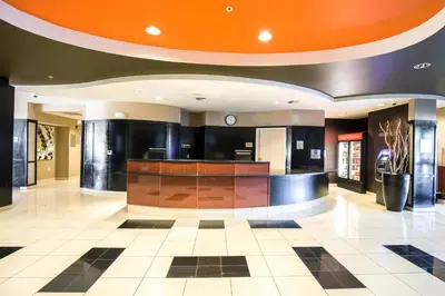 a lobby of a hotel with an orange ceiling at Courtyard by Marriott Merced in Merced