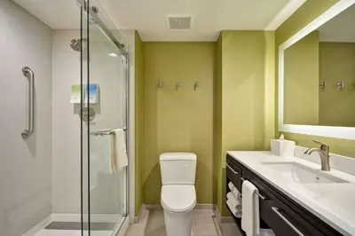 a bathroom with a shower and a toilet and a sink at Home2 Suites By Hilton Hanford Lemoore in Hanford