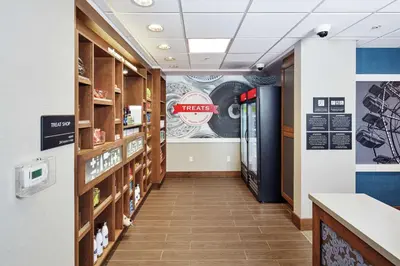 a hallway of a pharmacy with a sign that reads treats at Hampton Inn & Suites Sacramento at CSUS in Sacramento