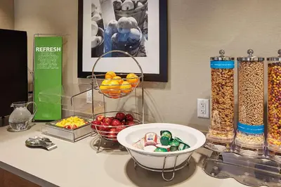 a counter top with a bowl of fruit and other food at Hampton Inn & Suites Sacramento at CSUS in Sacramento