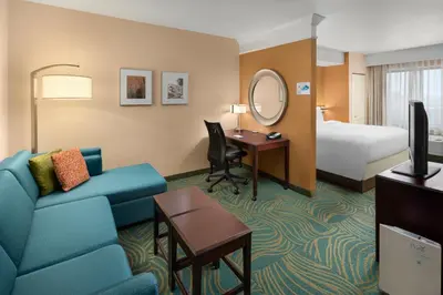 a hotel room with a couch and a bed at SpringHill Suites by Marriott Modesto in Modesto