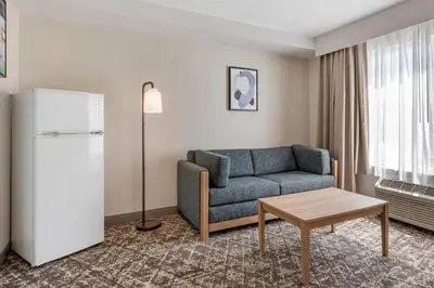 a living room with a couch and a table at Country Inn & Suites by Radisson, Modesto-Salida in Modesto