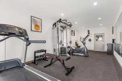 a gym with two tread machines in a room at Country Inn & Suites by Radisson, Modesto-Salida in Modesto