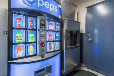 a drink machine in a building with a soda machine at Motel 6-Kingsburg, CA in Kingsburg
