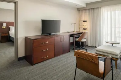 a hotel room with a desk and a flat screen tv at Courtyard Carson City in Carson City