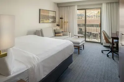 a hotel room with a bed and a balcony at Courtyard Carson City in Carson City