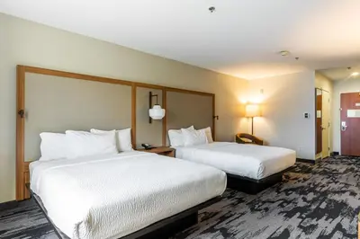 a hotel room with two beds with white sheets at Fairfield Inn & Suites Rancho Cordova in Rancho Cordova