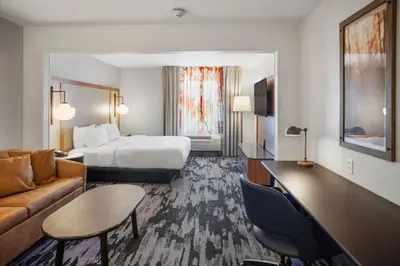 a hotel room with a bed and a couch at Fairfield Inn & Suites Rancho Cordova in Rancho Cordova