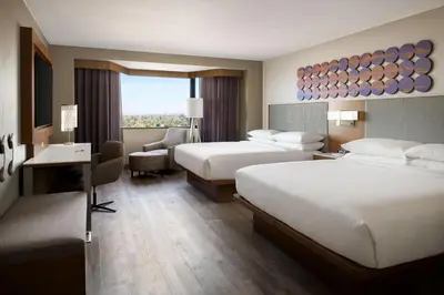 a hotel room with two beds and a desk at Sacramento Marriott Rancho Cordova in Rancho Cordova