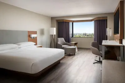 a hotel room with a bed and a desk and chair at Sacramento Marriott Rancho Cordova in Rancho Cordova