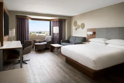 a hotel room with a large bed and a desk at Sacramento Marriott Rancho Cordova in Rancho Cordova