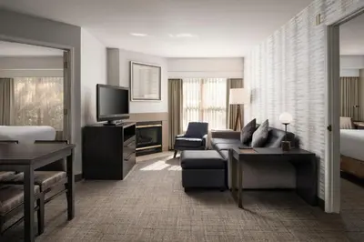 a living room with a couch and a tv at Residence Inn by Marriott Stockton in Stockton