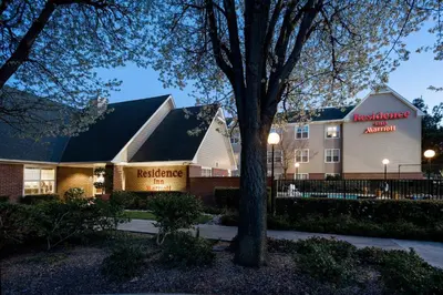 a hotel with a tree in front of a building at Residence Inn by Marriott Stockton in Stockton