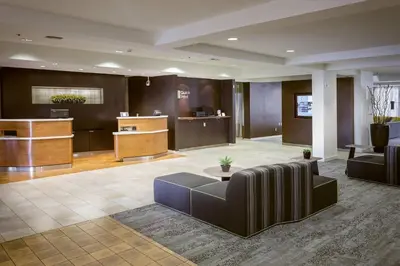 a lobby of a hotel with a couch and a table at Courtyard by Marriott Stockton in Stockton