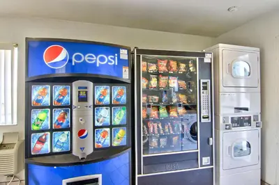 a pepsi soda machine next to a pepsi refrigerator at Motel 6-Sacramento, CA - South Sacramento and Elk Grove in Sacramento