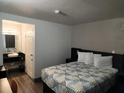 a hotel room with a bed and a sink at Motel 6-Sacramento, CA - South Sacramento and Elk Grove in Sacramento