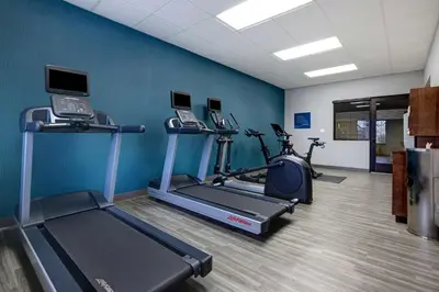 a gym with treadmill and exercise bikes in a room at Hampton Inn & Suites Tulare in Tulare