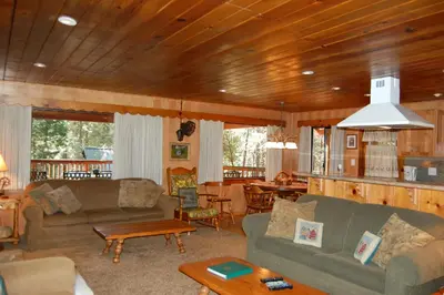 a living room with two couches and a table at 26 Deer Den in North Wawona