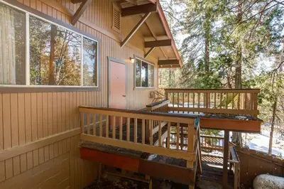 a front porch of a house with a deck at 24B Birds Eye View in Wawona