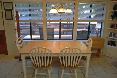 a dining room table with four chairs and a window at 23A Big Cedar in Wawona