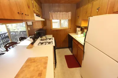 a kitchen with a white refrigerator and a stove at 6B Meadow View in Wawona
