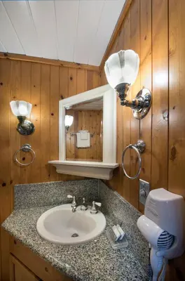 a bathroom with a sink and a mirror at 14 Chipmunk Hollow in Wawona