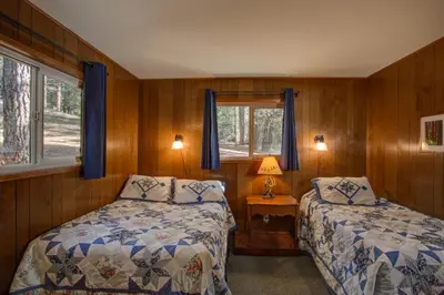 a bedroom with two beds and a window at 11B Sequoia House in Wawona