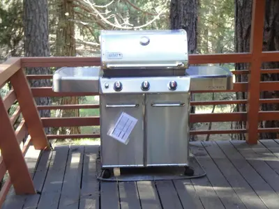 a grill on a deck with a sink at 39 River Song in North Wawona