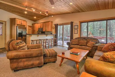 a living room with two couches and a table at 1L The Tree House in North Wawona