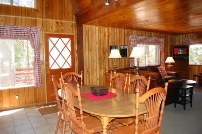 a dining room with a wooden table and chairs at 46R Manzanita Lodge in Wawona