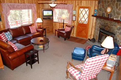 a living room with leather furniture and a fireplace at 46R Manzanita Lodge in Wawona