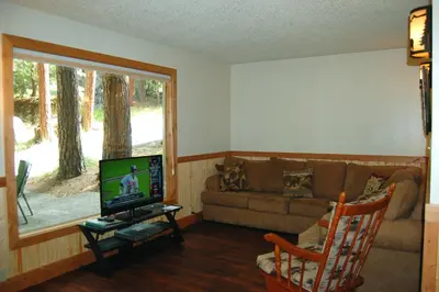 a living room with a couch and a television at 78 Ox Yoke in Wawona