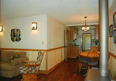 a kitchen and living room with a table and a couch at 78 Ox Yoke in Wawona