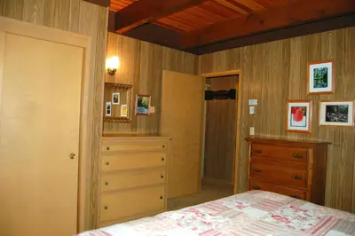 a bedroom with a bed and a dresser at 50 Spindlers Chalet in Wawona