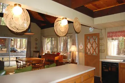 a kitchen and dining room with a table and chairs at 50 Spindlers Chalet in Wawona