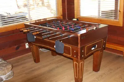 a large wooden foosball table in a room at 76 Howards Retreat in North Wawona