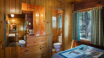 a wooden bathroom with a toilet and a sink at 3N Lockwood Lodge in Wawona