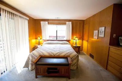 a bedroom with a bed and a window and a table at 48R The Tree House II in Wawona