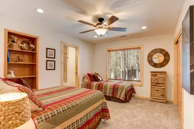 a bedroom with two beds and a ceiling fan at 36 Larkspur Lair in Wawona