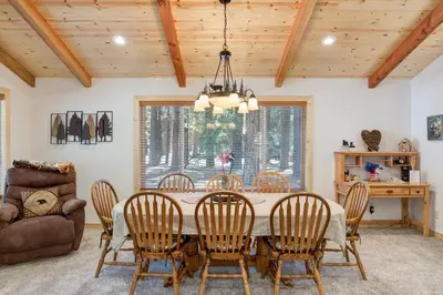 a dining room with a table and chairs and a couch at 36 Larkspur Lair in Wawona