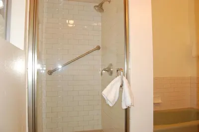 a shower with a glass door with a towel at 43A Mountain Retreat in Wawona