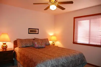 a bedroom with a bed and a ceiling fan at 5N Edmond's Place in Wawona