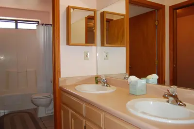 a bathroom with two sinks and a toilet at 5N Edmond's Place in Wawona